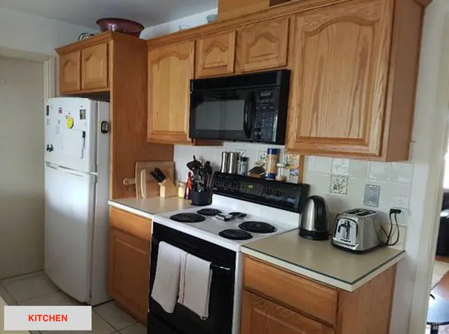 a kitchen with stainless steel appliances granite countertop a refrigerator stove and sink