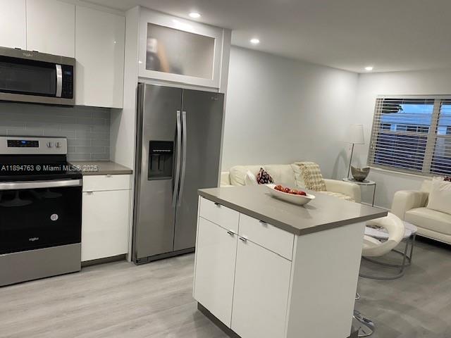 271 Durham, Unit 271 Deerfield Beach, FL 33442 - Photo 13 of 34 a kitchen with a sink cabinets and stainless steel appliances