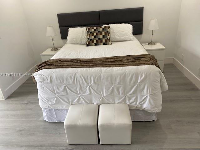 271 Durham, Unit 271 Deerfield Beach, FL 33442 - Photo 19 of 34 a large bed sitting in a bedroom next to a lamp