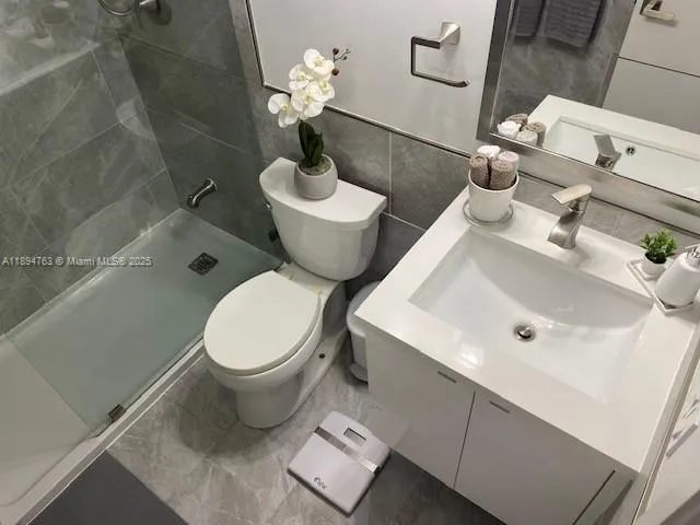 a white toilet sitting next to a bath tub