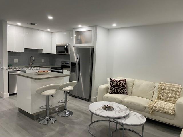 271 Durham, Unit 271 Deerfield Beach, FL 33442 - Photo 3 of 34 a living room with furniture and kitchen view