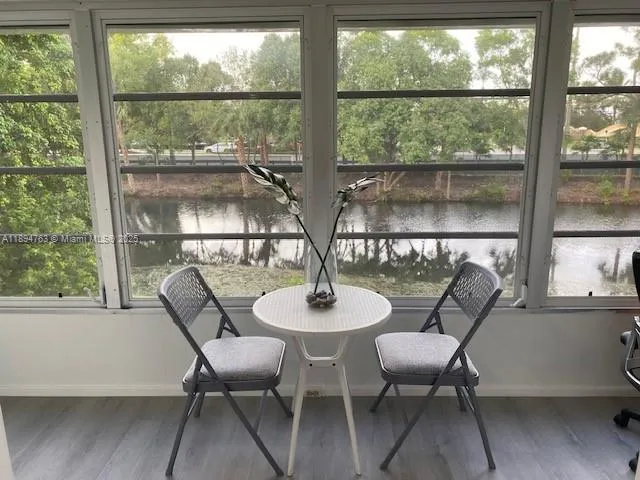 a dining room with furniture window and outdoor view