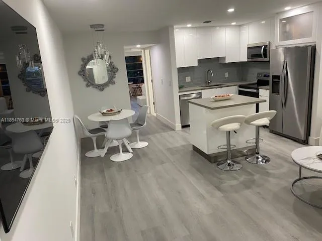 a kitchen with a sink appliances and cabinets