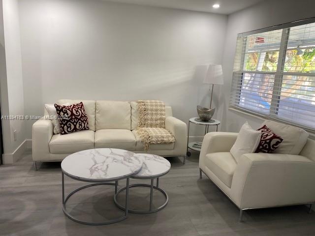 271 Durham, Unit 271 Deerfield Beach, FL 33442 - Photo 9 of 34 a living room with furniture and a large window