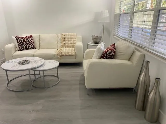 a living room with furniture and a window