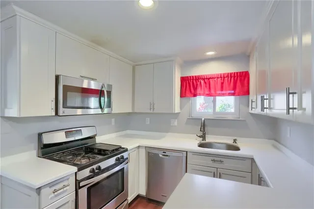 a kitchen that has a sink and a stove