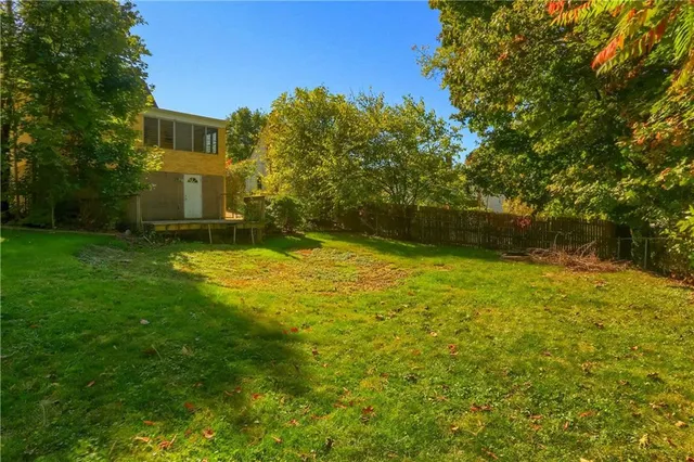 a view of a yard with a house in the background