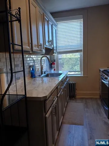 a kitchen with stainless steel appliances granite countertop a sink stove and cabinets