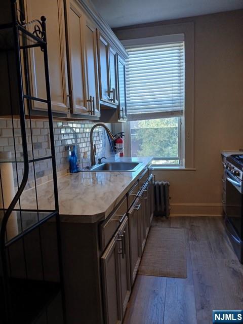 70 Main Street, Unit 3 Little Falls, NJ 07424 - Photo 1 of 10 a kitchen with stainless steel appliances granite countertop a sink stove and cabinets