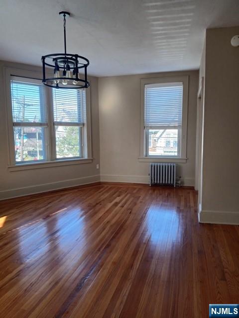 70 Main Street, Unit 3 Little Falls, NJ 07424 - Photo 4 of 10 an empty room with wooden floor and windows