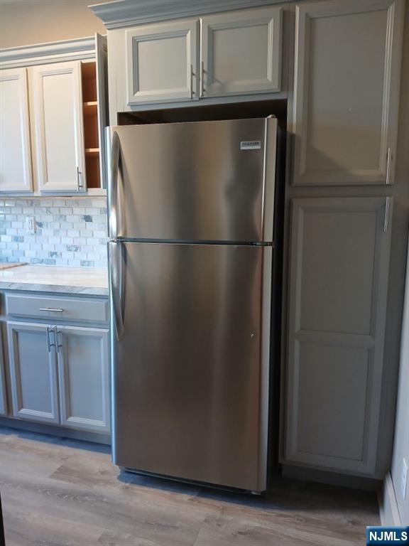70 Main Street, Unit 3 Little Falls, NJ 07424 - Photo 5 of 10 a view of a refrigerator in kitchen and white cabinets