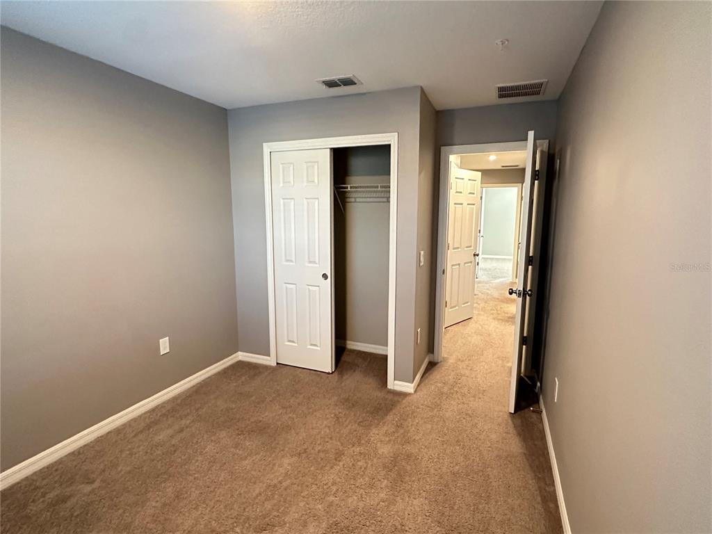 10834 Wyne Tree Orlando, FL 32824 - Photo 17 of 33 an empty room with windows and closet