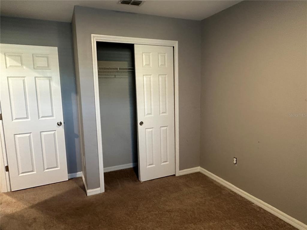10834 Wyne Tree Orlando, FL 32824 - Photo 19 of 33 an empty room that has a wooden cupboard