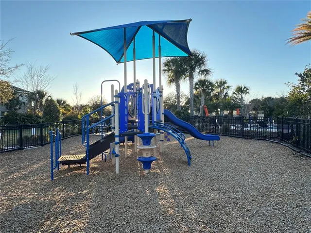 a view of outdoor space with playground and green space