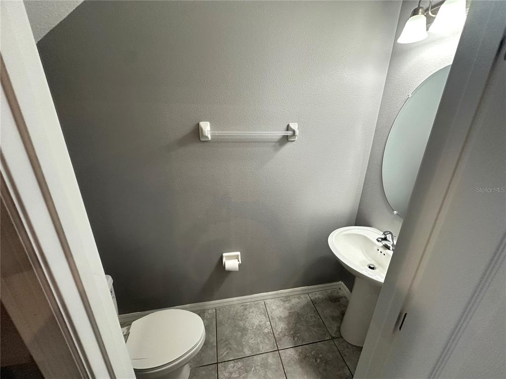 10834 Wyne Tree Orlando, FL 32824 - Photo 8 of 33 a bathroom with a sink a toilet and a mirror