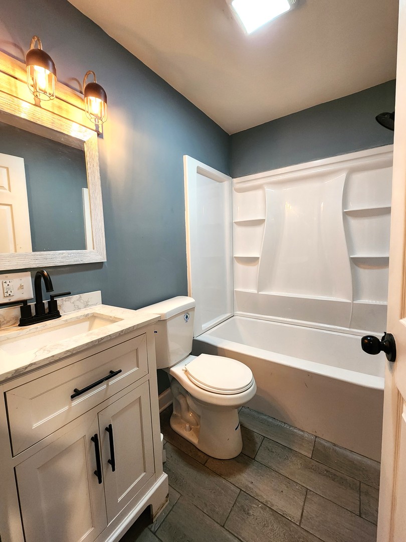 62 Seneca Street Elgin, IL 60120 - Photo 11 of 20 a bathroom with a sink toilet and shower