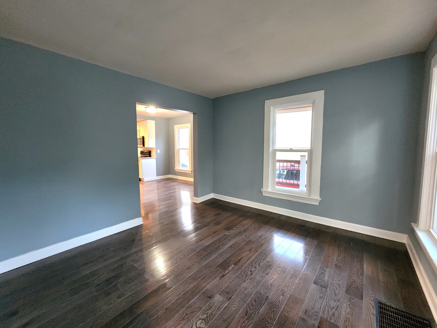 62 Seneca Street Elgin, IL 60120 - Photo 13 of 20 an empty room with wooden floor and windows