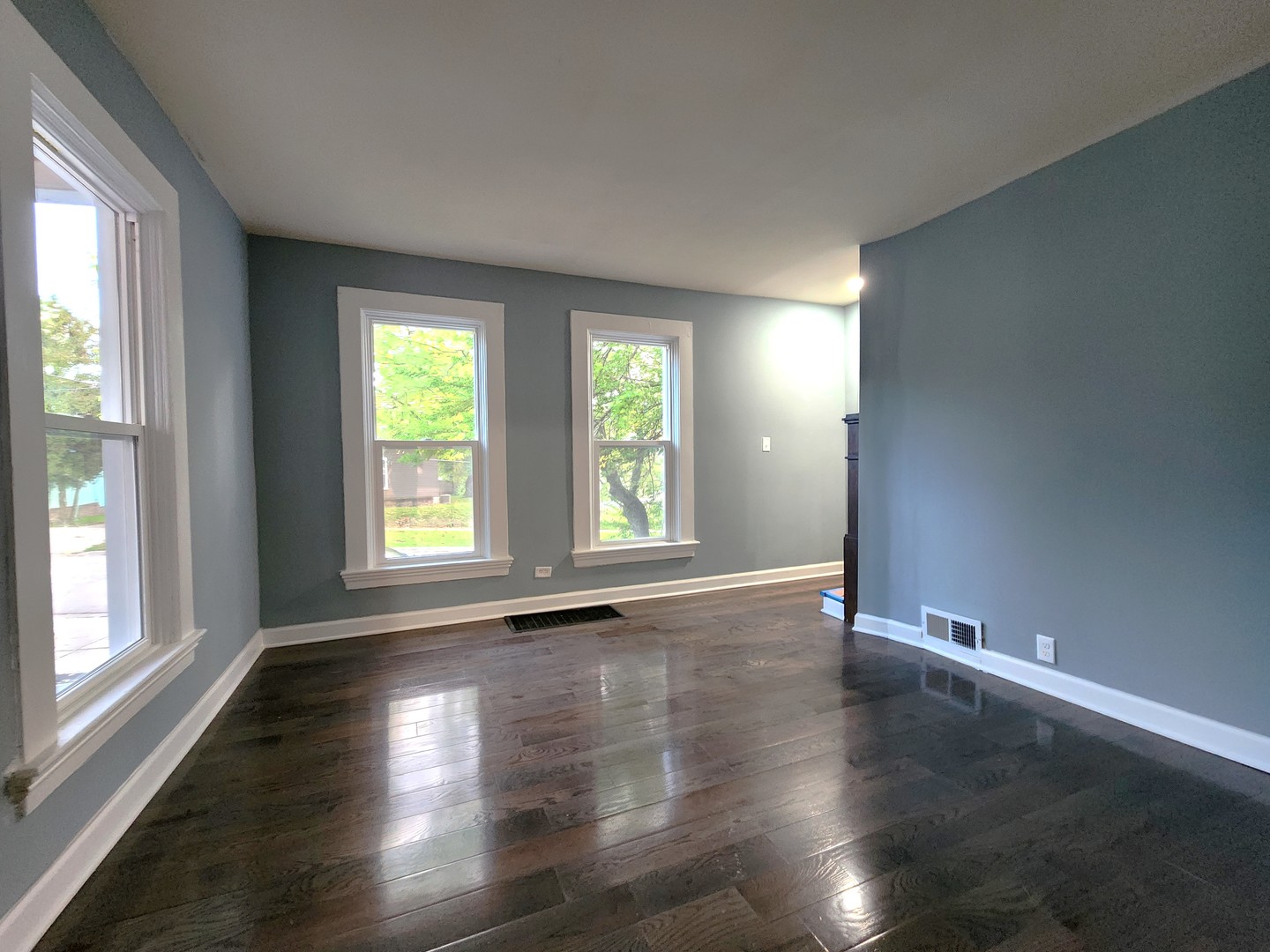 62 Seneca Street Elgin, IL 60120 - Photo 14 of 20 an empty room with wooden floor and windows