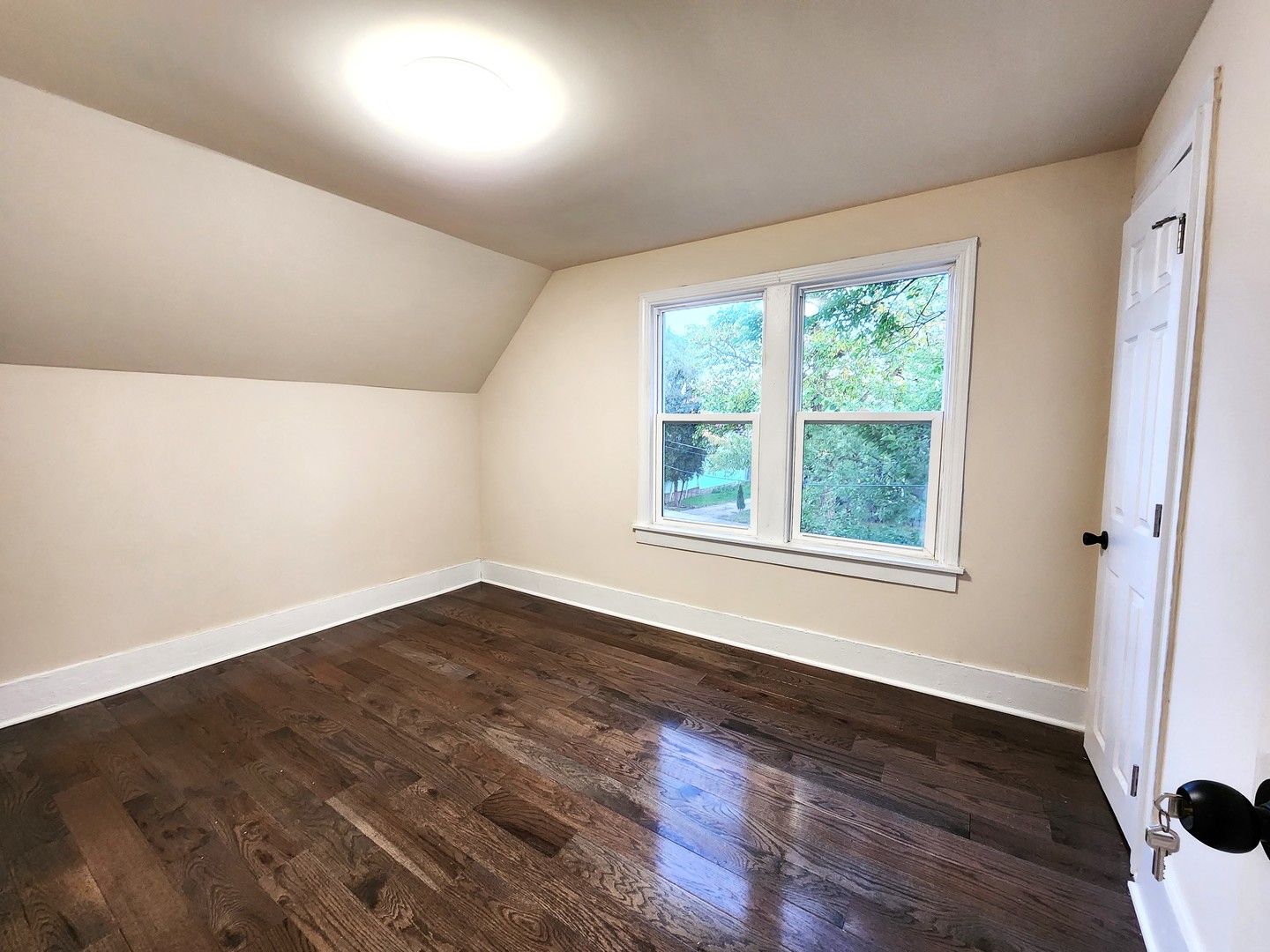 62 Seneca Street Elgin, IL 60120 - Photo 15 of 20 a view of an empty room with wooden floor and a window