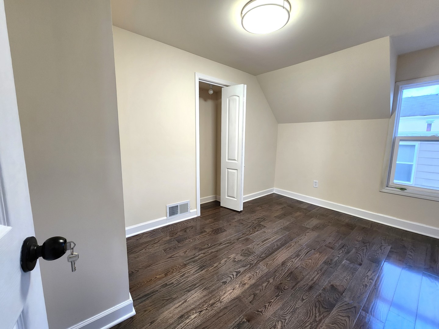 62 Seneca Street Elgin, IL 60120 - Photo 16 of 20 an empty room with wooden floor and windows