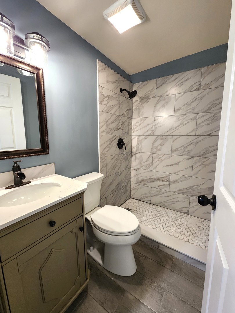 62 Seneca Street Elgin, IL 60120 - Photo 17 of 20 a bathroom with a sink toilet and shower