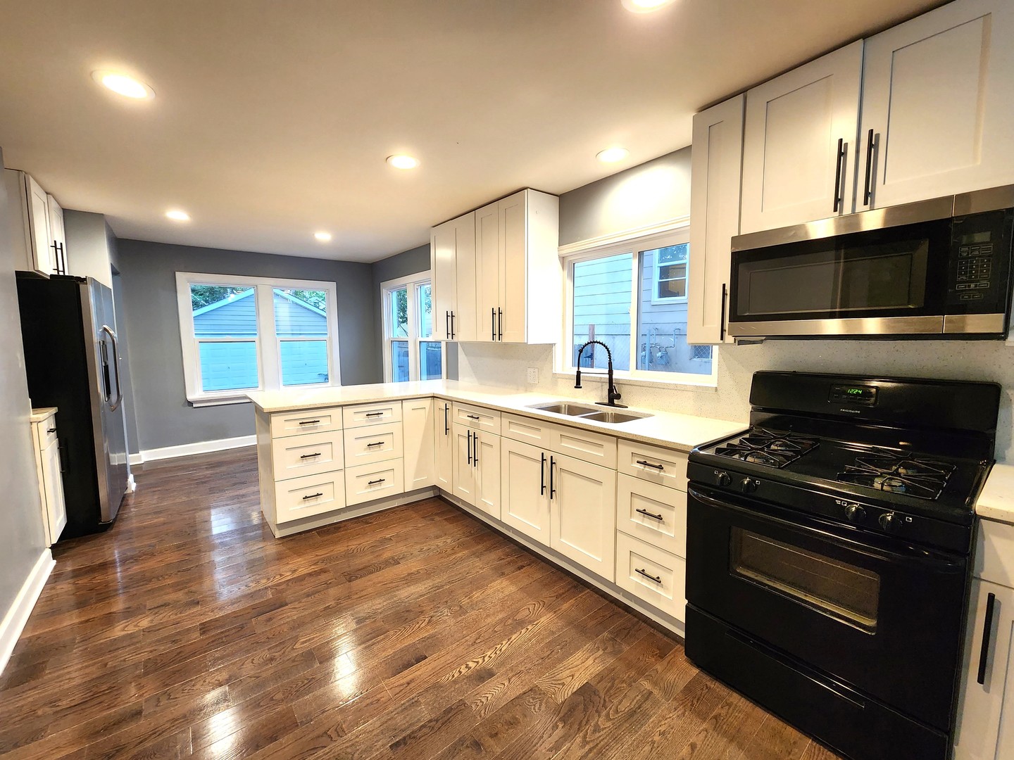 62 Seneca Street Elgin, IL 60120 - Photo 2 of 20 a kitchen with stainless steel appliances a stove sink microwave and cabinets