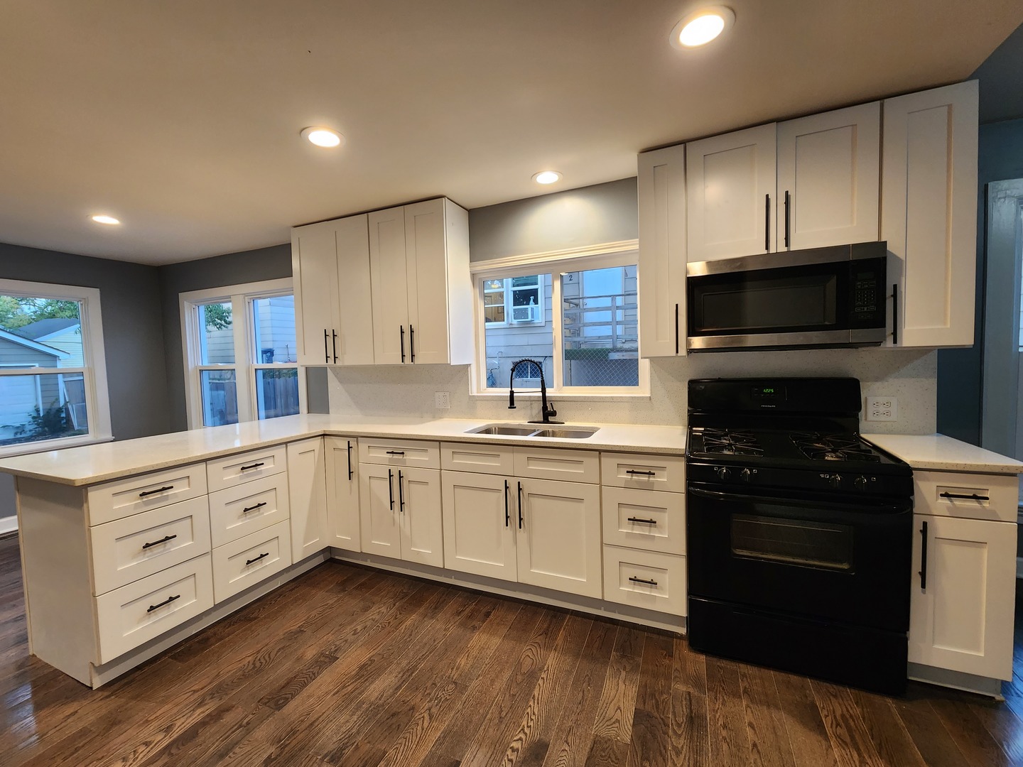 62 Seneca Street Elgin, IL 60120 - Photo 3 of 20 a kitchen with stainless steel appliances granite countertop a stove a sink and a microwave