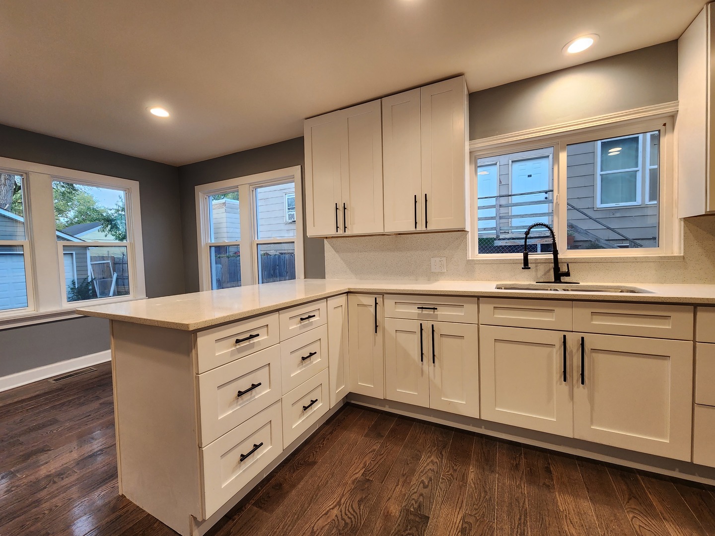 62 Seneca Street Elgin, IL 60120 - Photo 4 of 20 a kitchen with cabinets wooden floor and a window