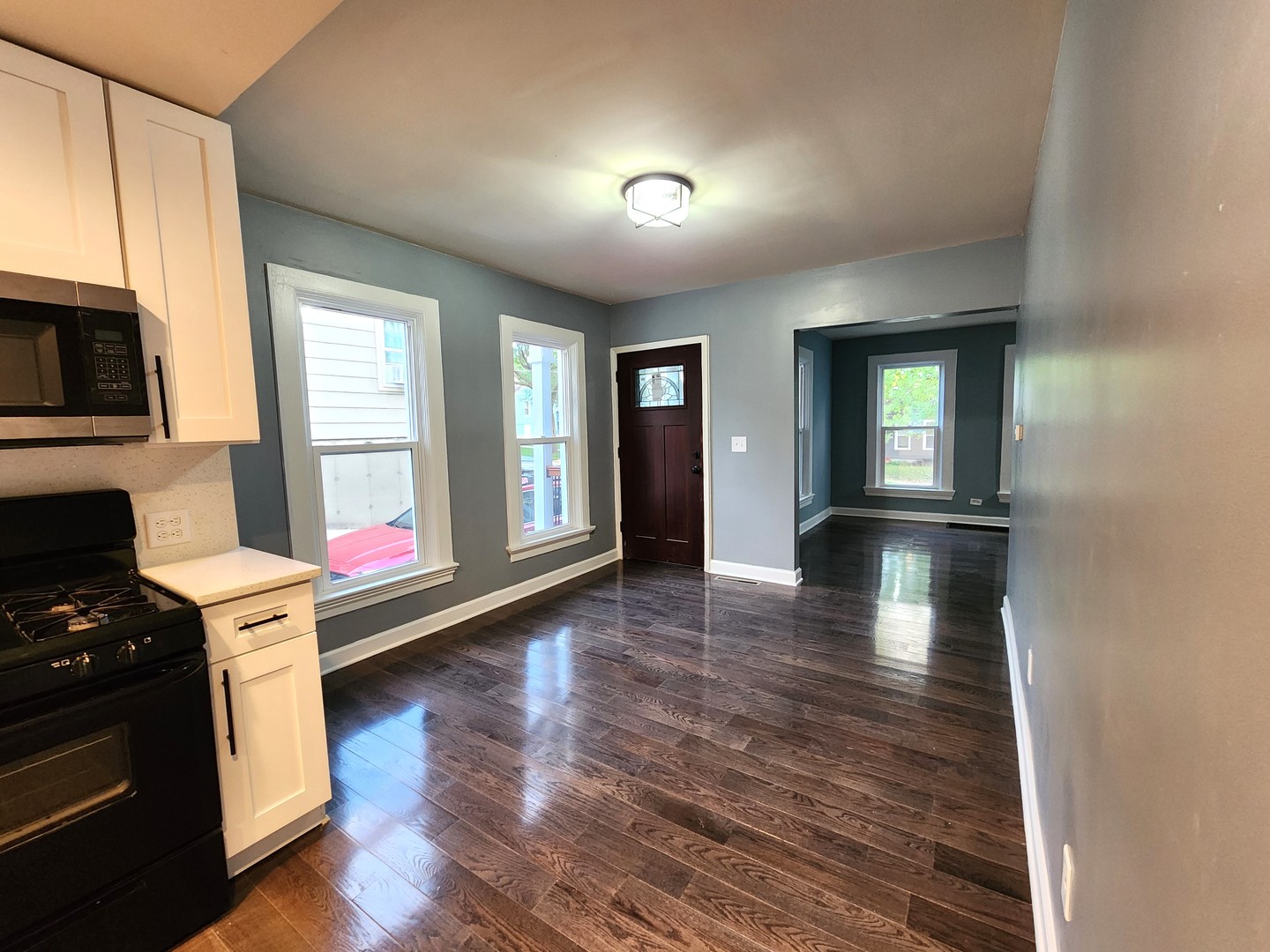 62 Seneca Street Elgin, IL 60120 - Photo 10 of 20 a view of a kitchen with a stove wooden cabinets and wooden floor