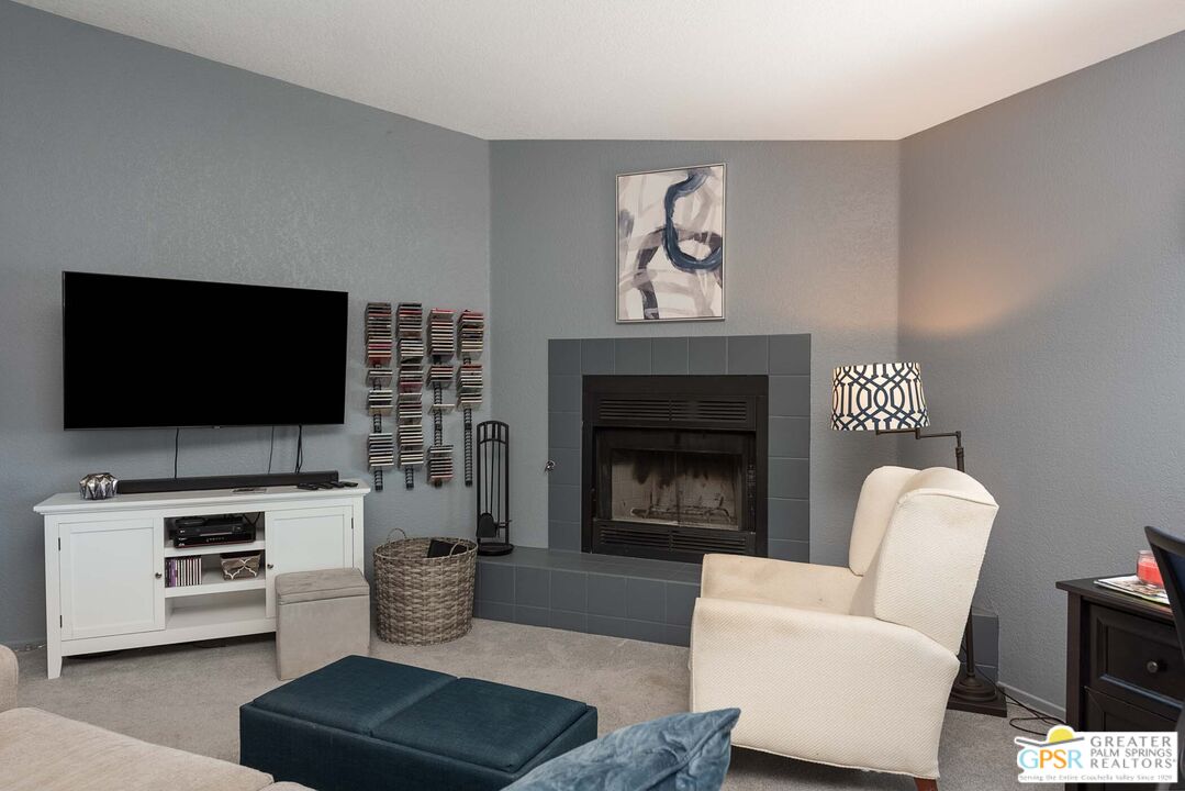 9760 Capiland Road Desert Hot Springs, CA 92240 - Photo 5 of 16 a living room with furniture and a flat screen tv