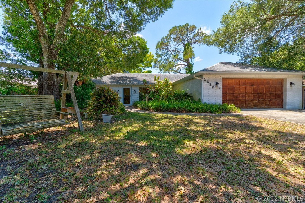 a front view of a house with a yard and a garage