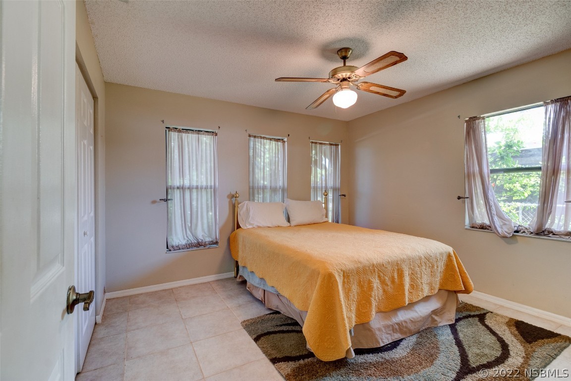 2628 Queen Palm Drive Edgewater, FL 32141 - Photo 11 of 15 a bedroom with a bed and window