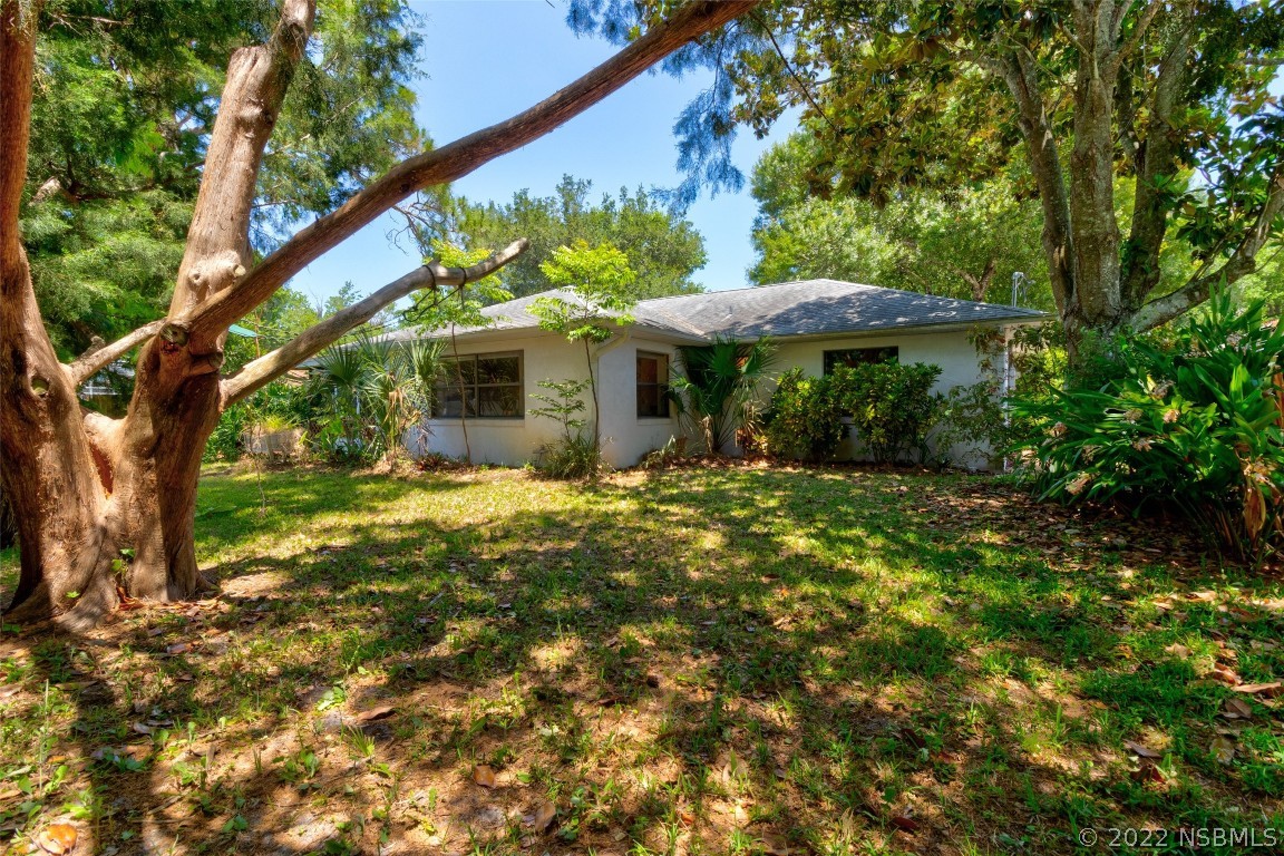 2628 Queen Palm Drive Edgewater, FL 32141 - Photo 14 of 15 a view of a house with a yard