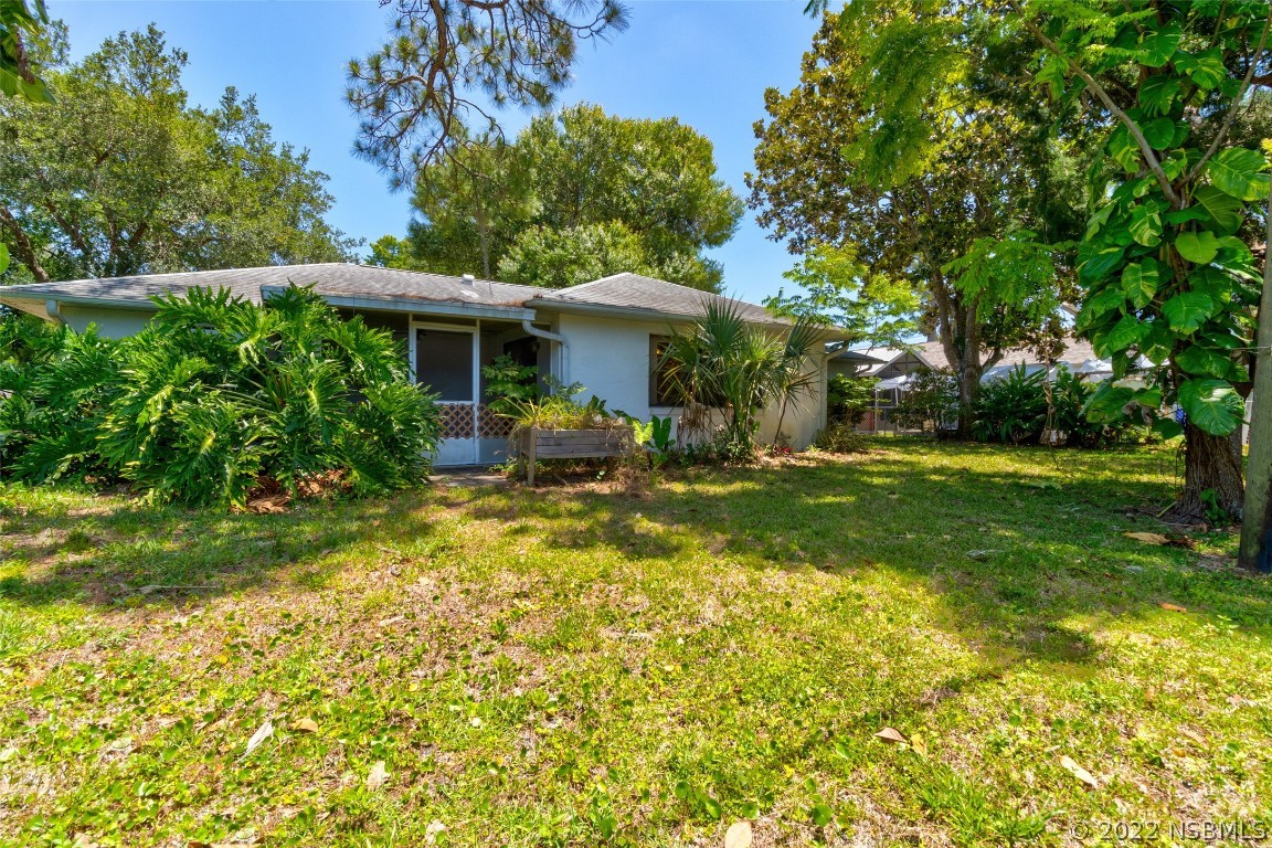 2628 Queen Palm Drive Edgewater, FL 32141 - Photo 15 of 15 a backyard of a house with yard table and chairs