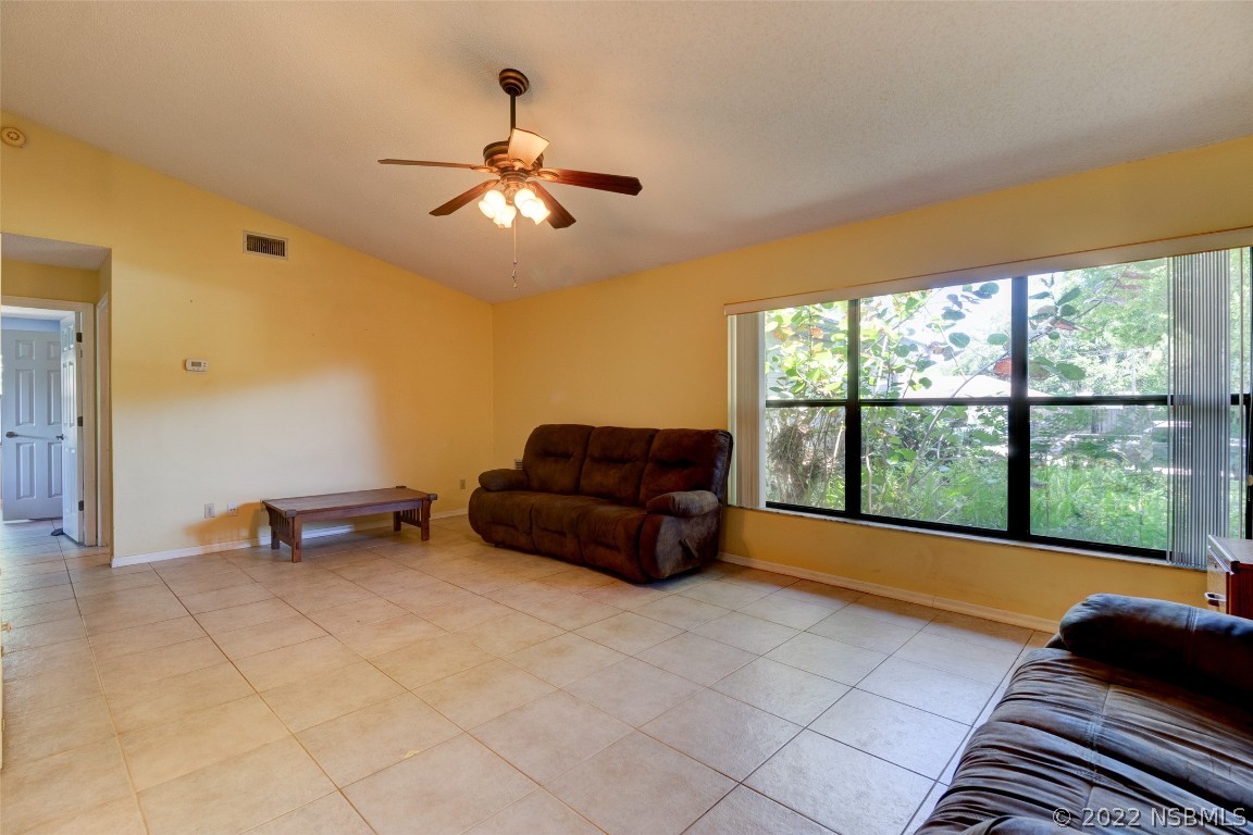 2628 Queen Palm Drive Edgewater, FL 32141 - Photo 4 of 15 a room with a large window and chandelier
