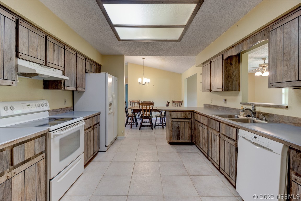2628 Queen Palm Drive Edgewater, FL 32141 - Photo 5 of 15 a kitchen with stainless steel appliances granite countertop a sink and cabinets
