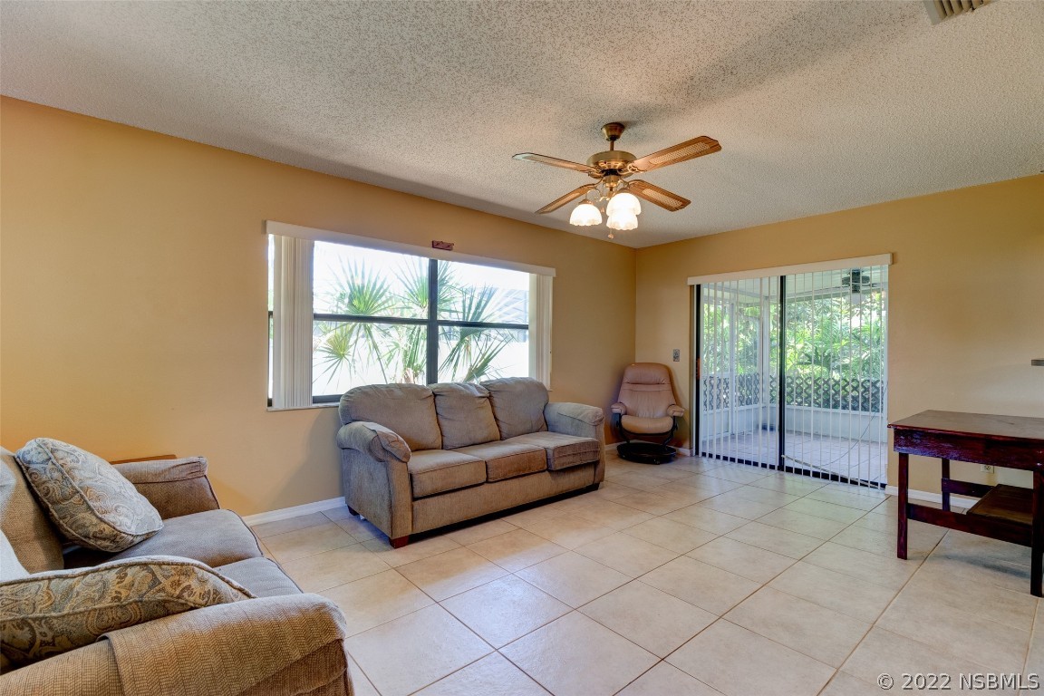 2628 Queen Palm Drive Edgewater, FL 32141 - Photo 7 of 15 a living room with furniture and a window