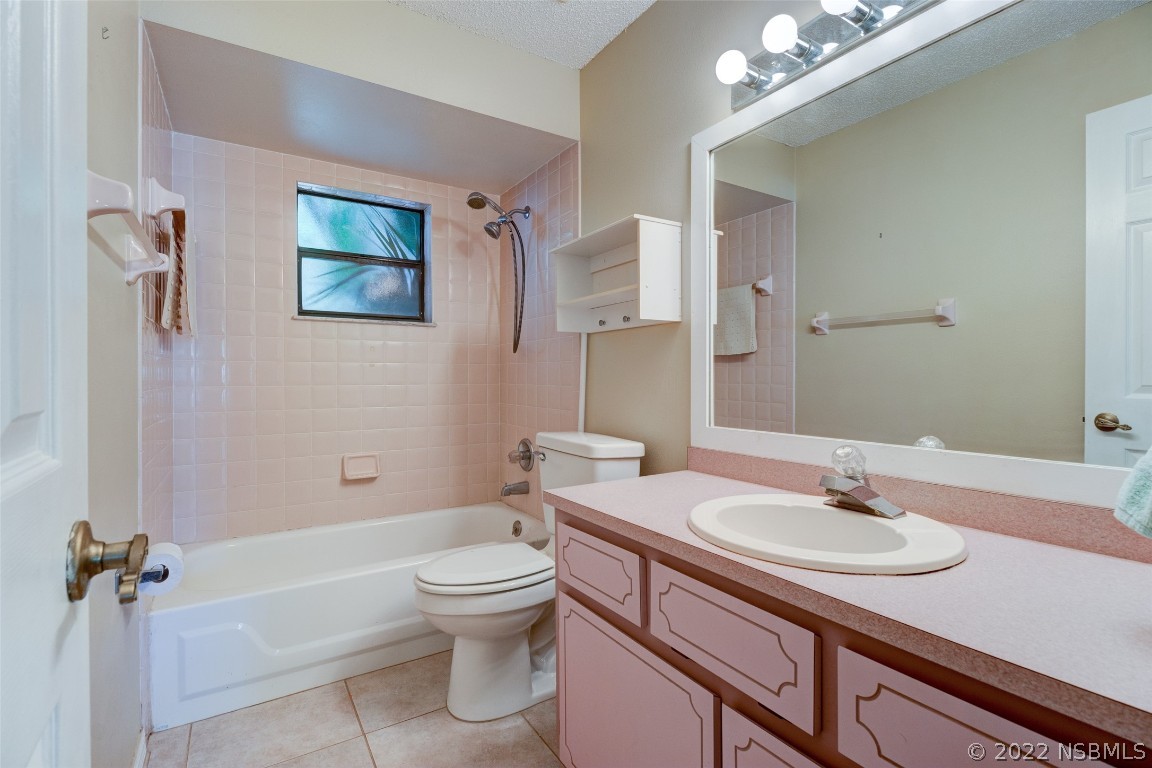 2628 Queen Palm Drive Edgewater, FL 32141 - Photo 9 of 15 a bathroom with a sink a toilet and shower