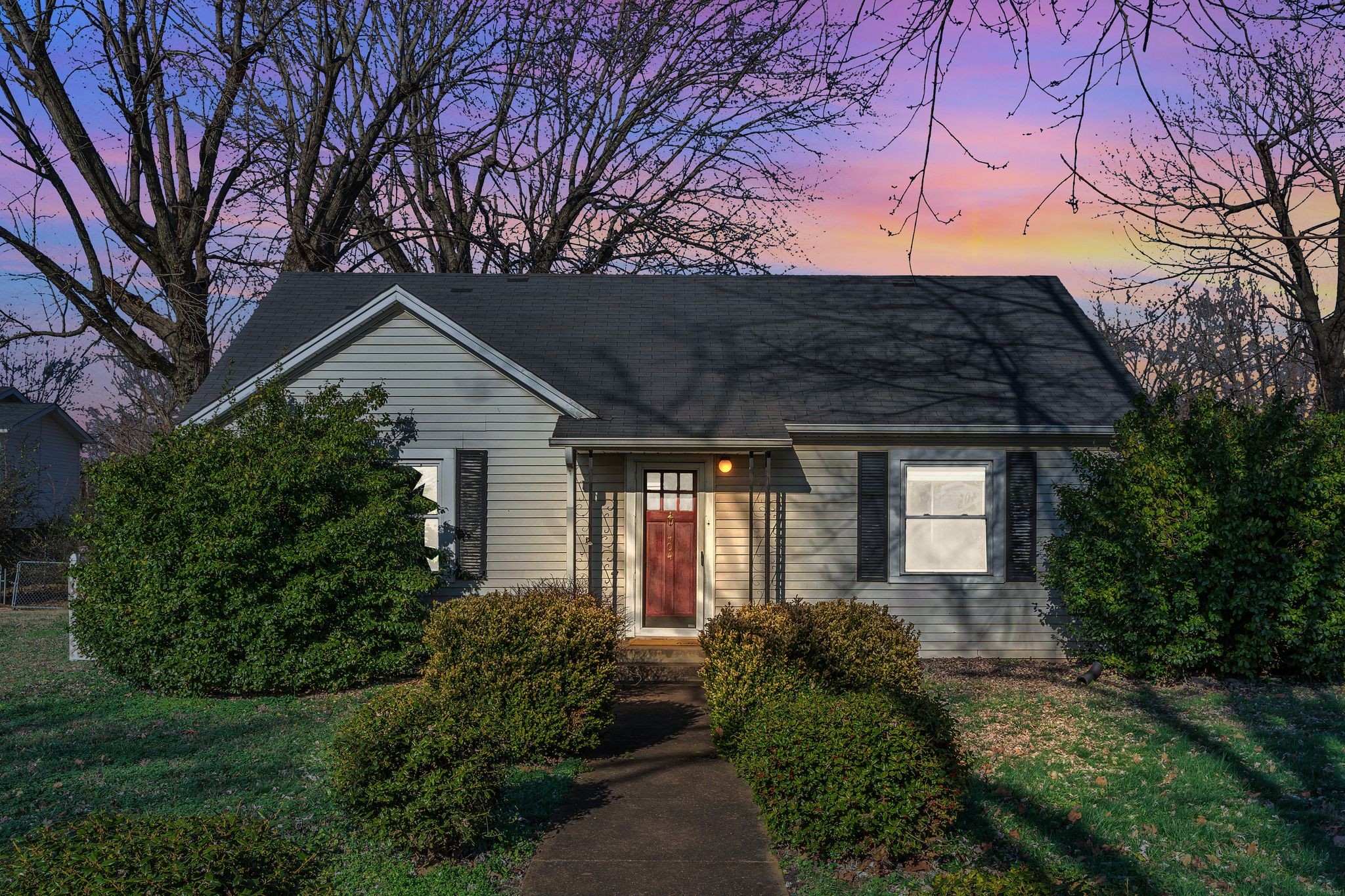 a front view of house with a garden