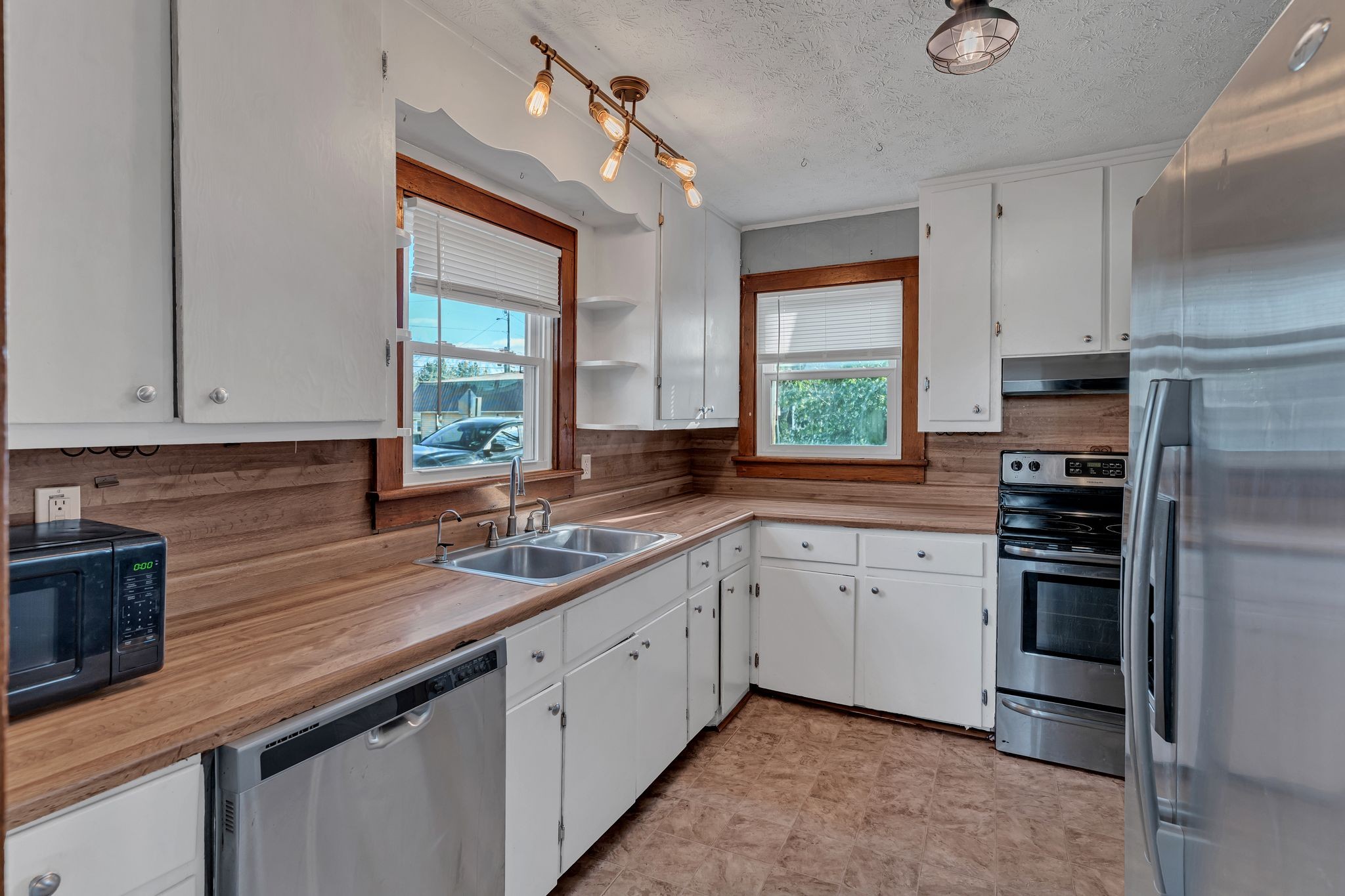 404 Gibson Street Portland, TN 37148 - Photo 18 of 26 a kitchen with a sink cabinets stainless steel appliances and a window