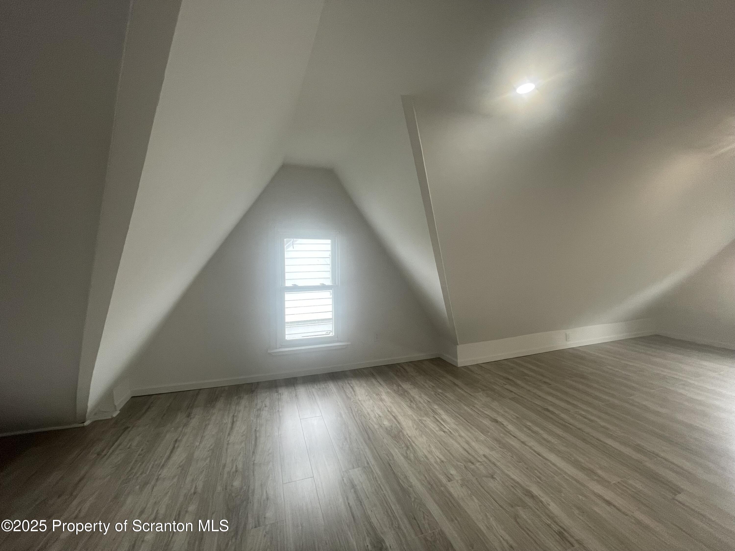 608 North Sumner Avenue, Unit 608 Scranton, PA 18504 - Photo 11 of 22 an empty room with wooden floor and windows