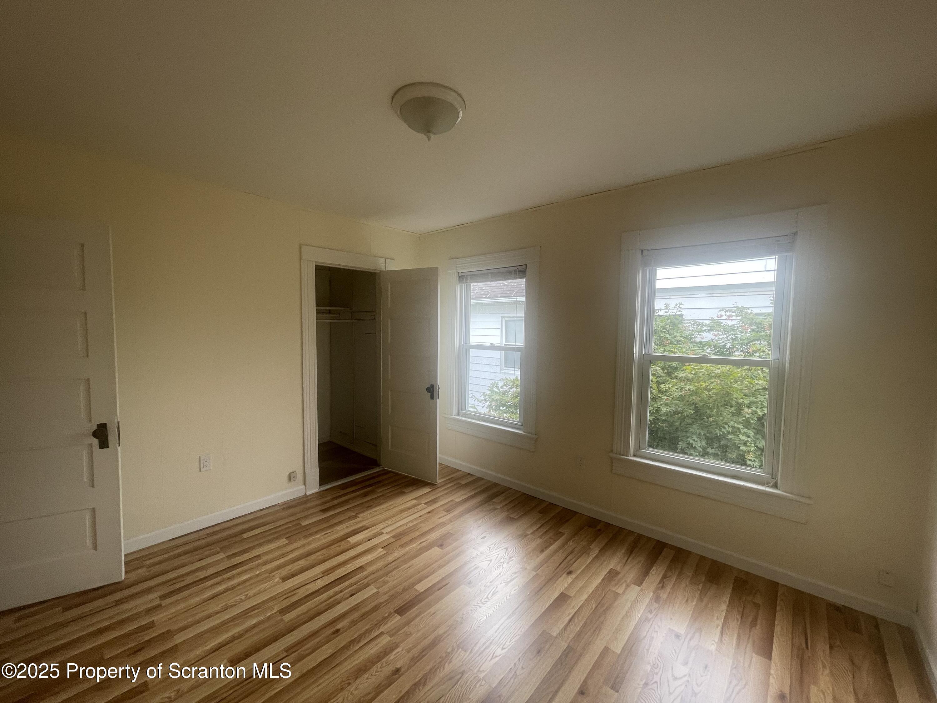608 North Sumner Avenue, Unit 608 Scranton, PA 18504 - Photo 13 of 22 a view of an empty room with wooden floor and a window