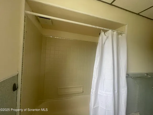 a bathroom with a shower and a tub