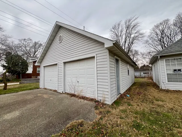 a view of a house with a yard and garage