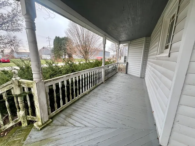 a view of a porch with wooden floor and stairs