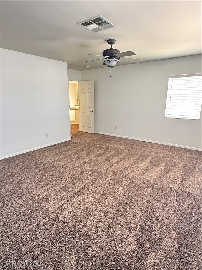 10975 Calcedonian Street Las Vegas, NV 89141 - Photo 19 of 25 This spacious bedroom offers ample comfort and style with plush carpeting and natural light.