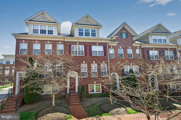 a front view of a residential apartment building with a yard