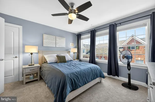 a bedroom with a bed and a large window