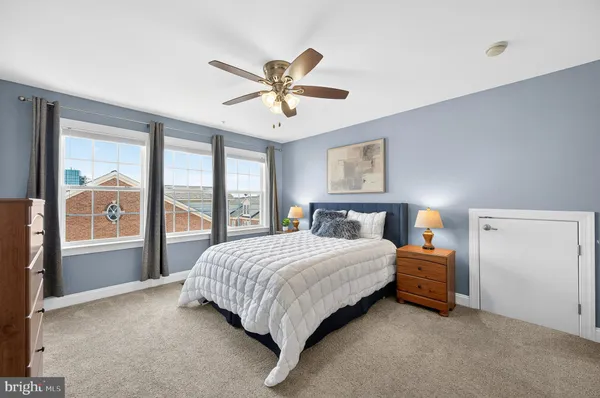 a bedroom with a bed and a large window