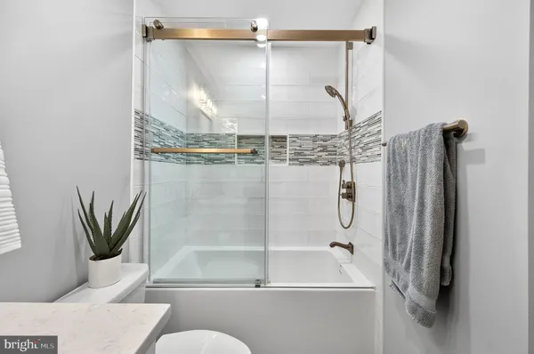 a bathroom with a shower and a wooden floor
